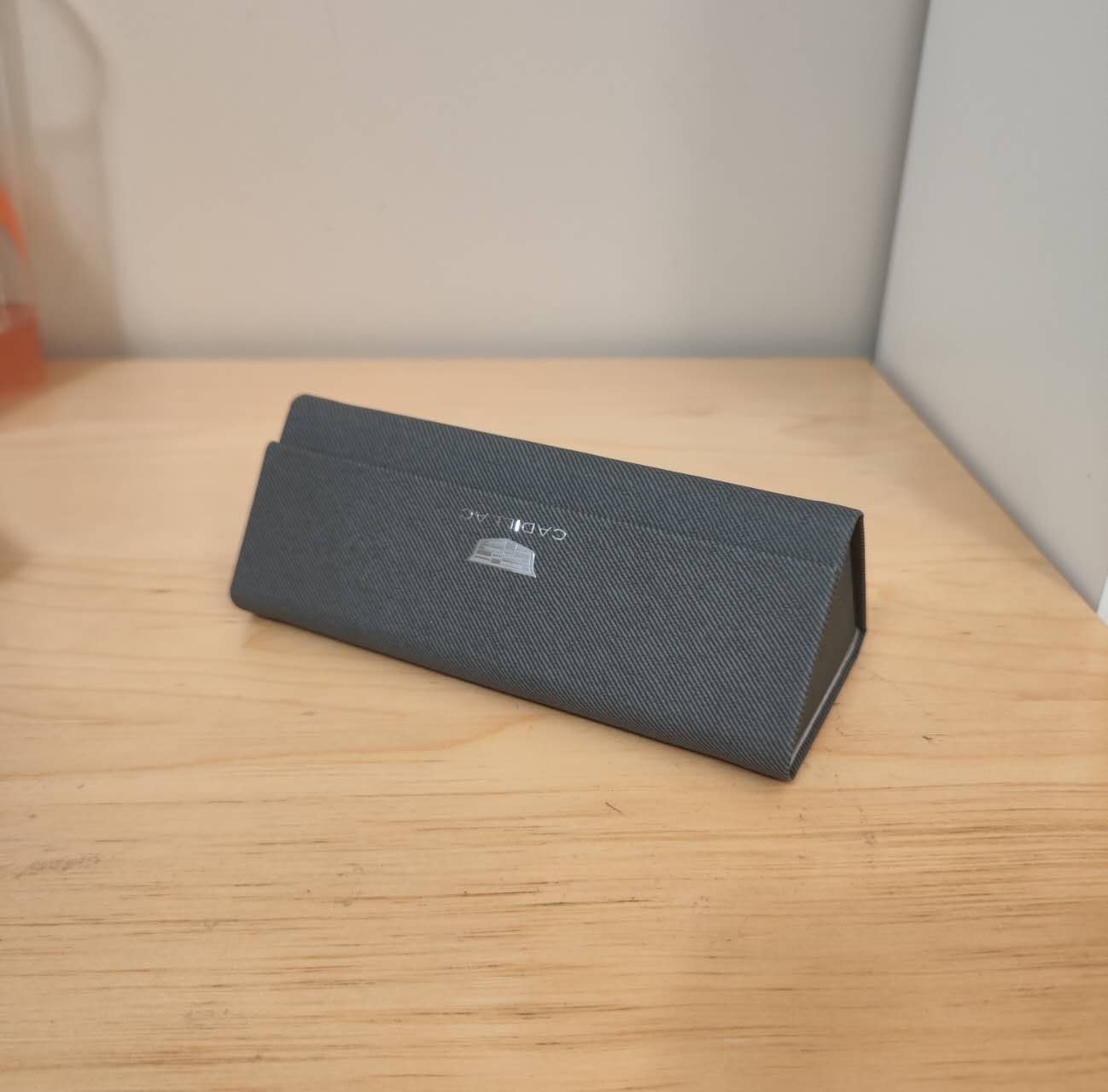 This is my glasses case, a triangular folding box. It is easy to carry and has a simple shape.